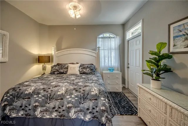 a dining room with furniture a rug a potted plant and wooden floor