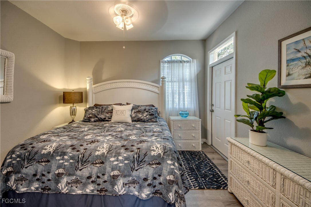 3181 Matecumbe Key Road, Unit 11 Punta Gorda, FL 33955 - Photo 37 of 50 a bedroom with a large bed and a potted plant