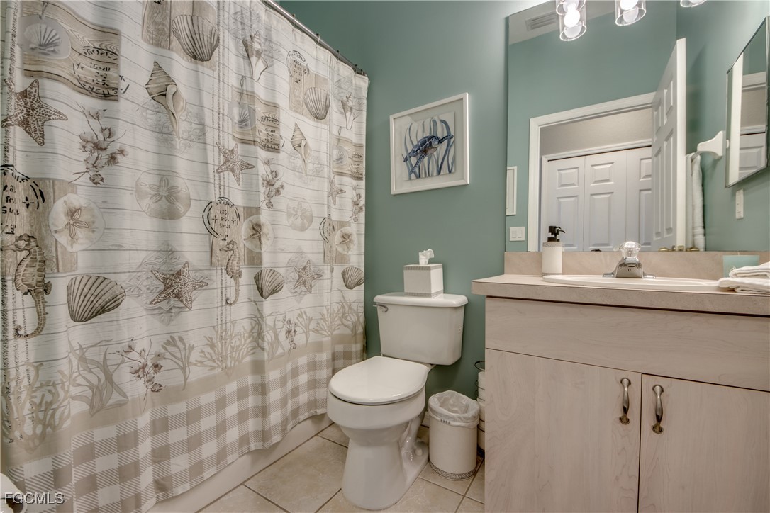 3181 Matecumbe Key Road, Unit 11 Punta Gorda, FL 33955 - Photo 38 of 50 a bathroom with a sink a toilet and a mirror