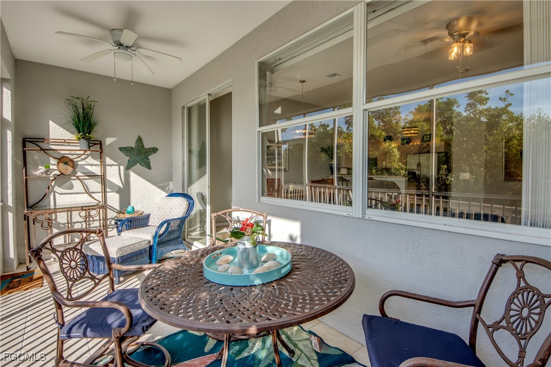 3181 Matecumbe Key Road, Unit 11 Punta Gorda, FL 33955 - Photo 44 of 50 a dining room with furniture a rug a potted plant and wooden floor