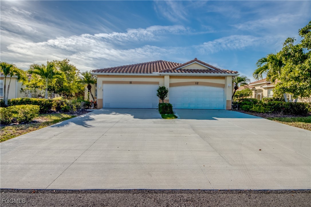 3181 Matecumbe Key Road, Unit 11 Punta Gorda, FL 33955 - Photo 7 of 50 a front view of a house with a yard and garage