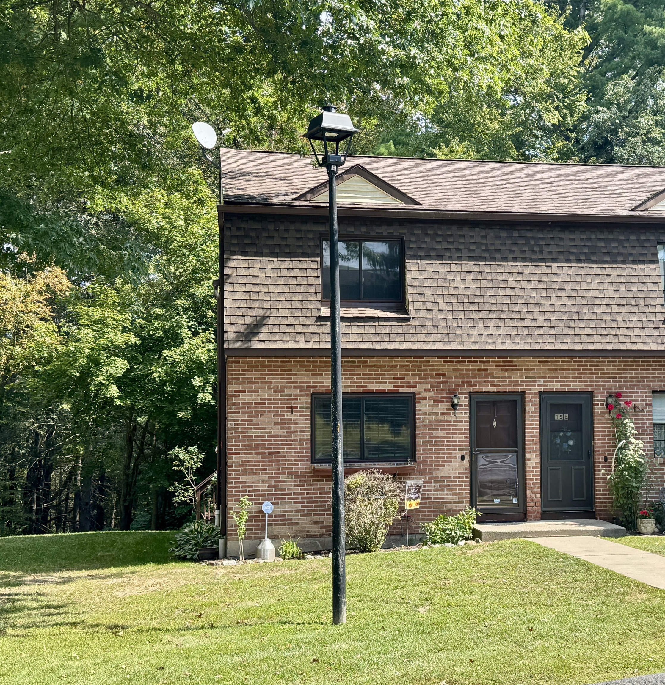 143 Pine Hill Road, Unit 15F Thomaston, CT 06787 - Photo 2 of 14 a house view with a garden space