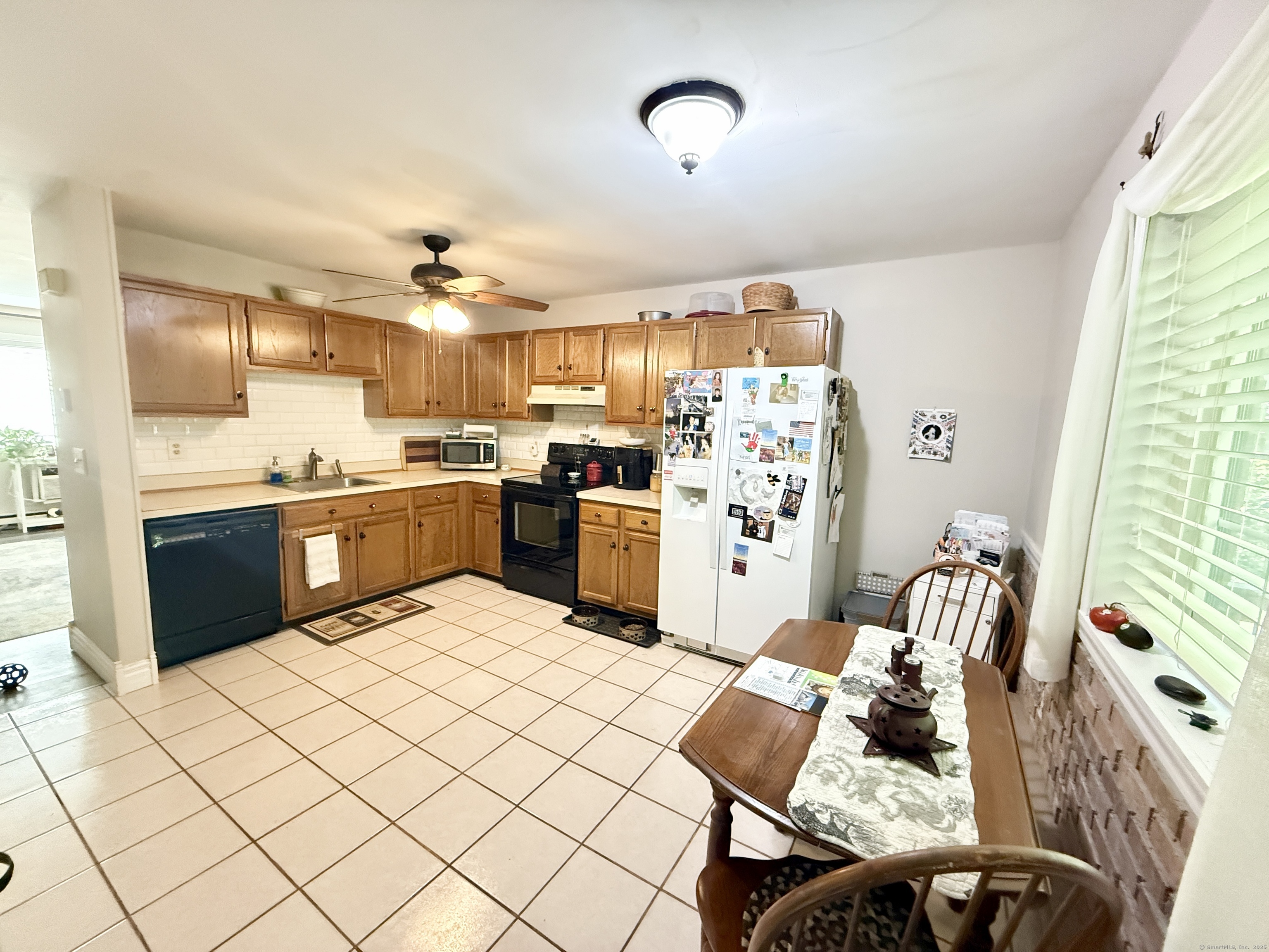 143 Pine Hill Road, Unit 15F Thomaston, CT 06787 - Photo 6 of 14 a kitchen with stainless steel appliances kitchen island granite countertop a sink and cabinets