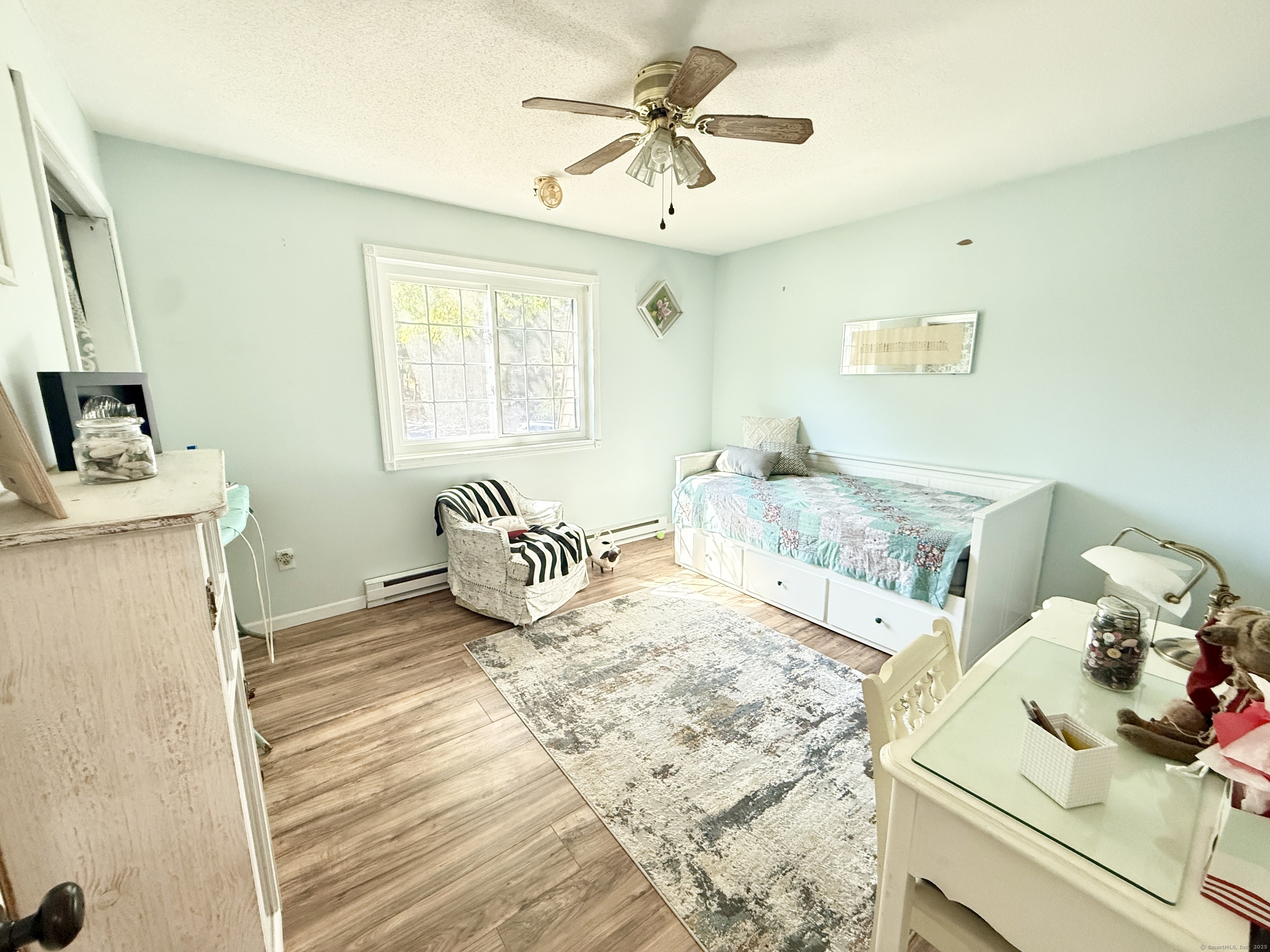 143 Pine Hill Road, Unit 15F Thomaston, CT 06787 - Photo 8 of 14 a bedroom with a bed and a chandelier