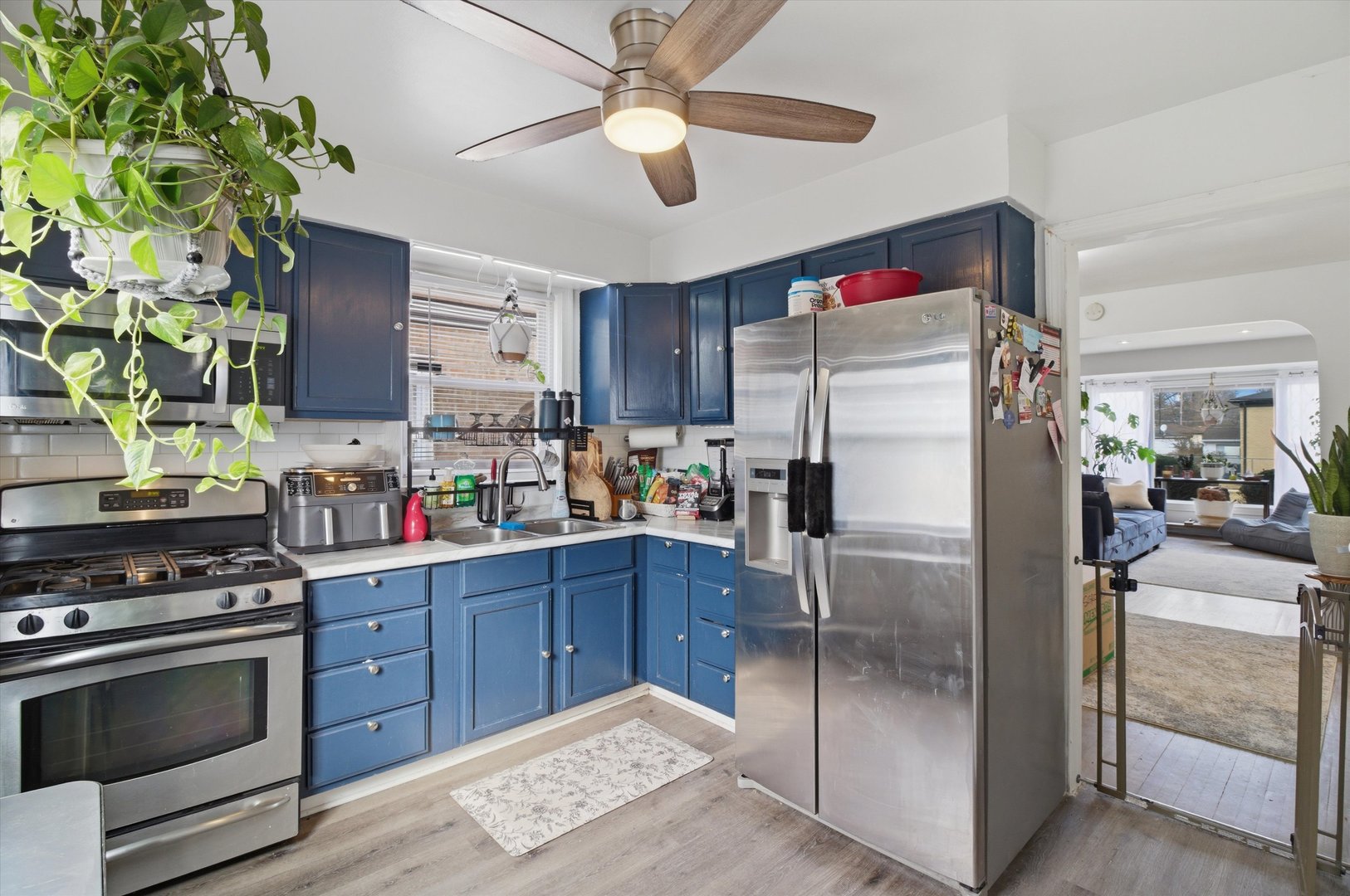 1107 West 101st Street Chicago, IL 60643 - Photo 14 of 28 a kitchen with stainless steel appliances granite countertop a refrigerator a stove and a sink with wooden floor
