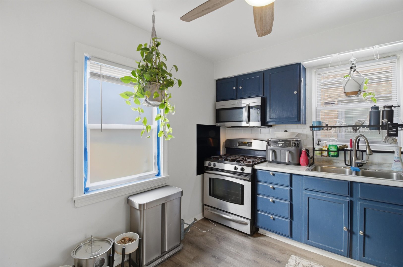1107 West 101st Street Chicago, IL 60643 - Photo 15 of 28 a kitchen with stainless steel appliances granite countertop a sink a stove and a wooden floors