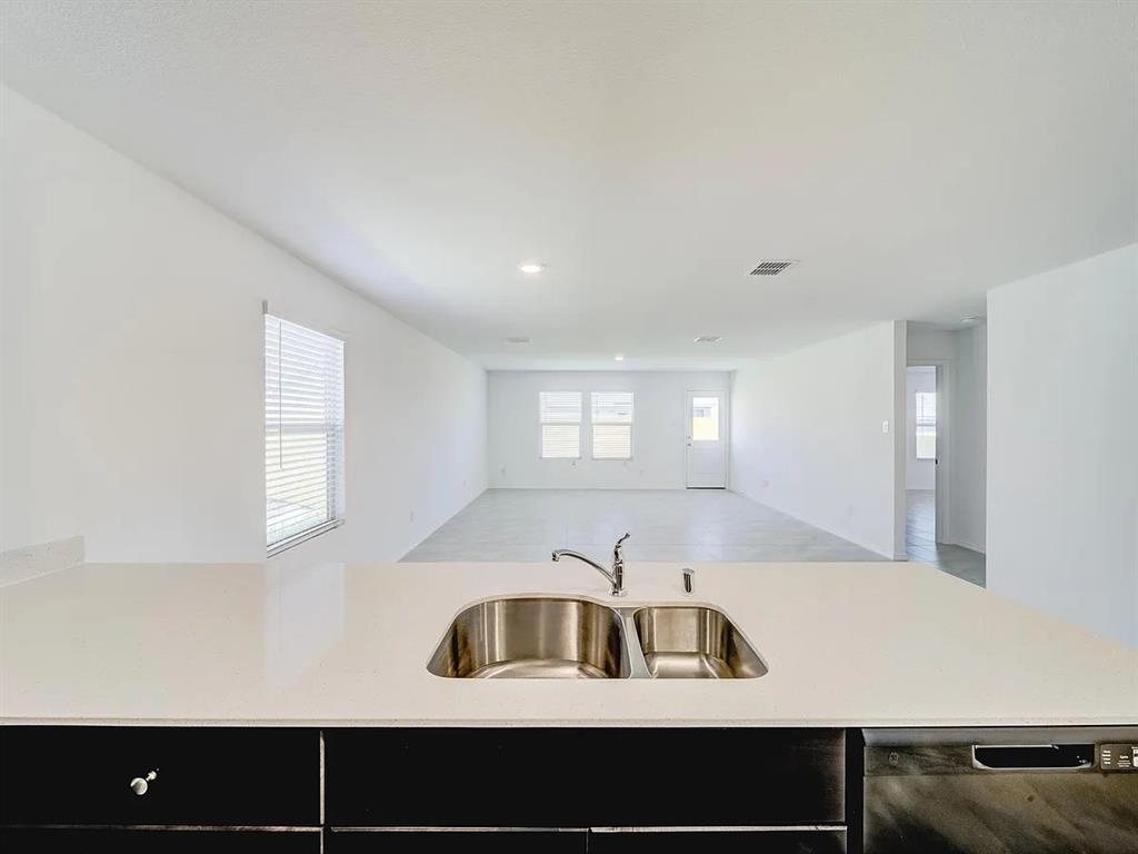 352 Sun Bluff Road Fort Worth, TX 76052 - Photo 11 of 33 Kitchen island with a double basin stainless steel sink and a gooseneck faucet