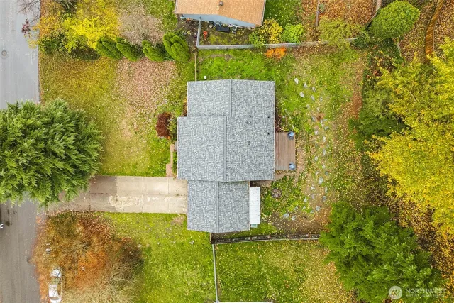 an aerial view of a house with a yard basket ball court and outdoor seating