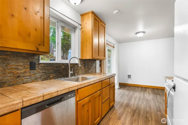 a kitchen with wooden floors and sink