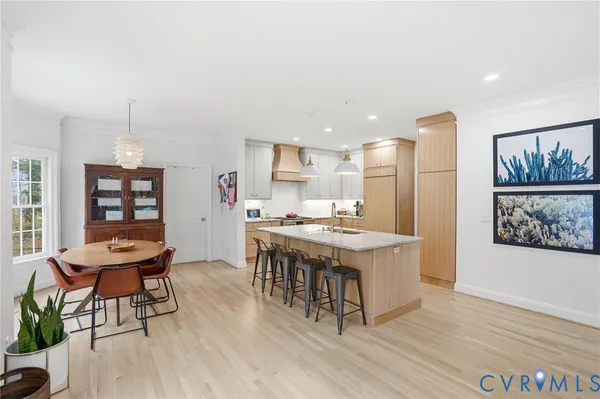 a large kitchen with a table and chairs in it