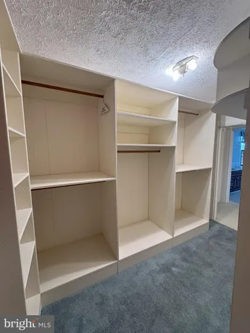 a view of an empty room with a cabinet