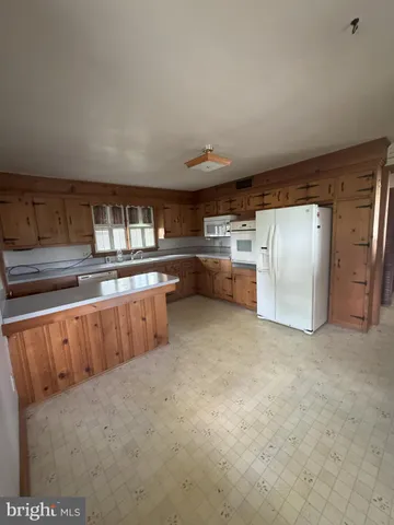 a kitchen with stainless steel appliances granite countertop a refrigerator and stove