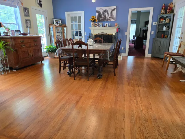 a view of a dining room with furniture and wooden floor