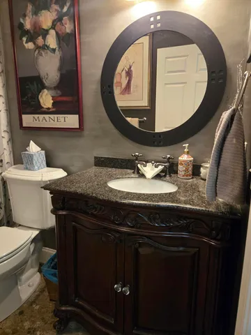 a white toilet sitting next to a bathroom sink