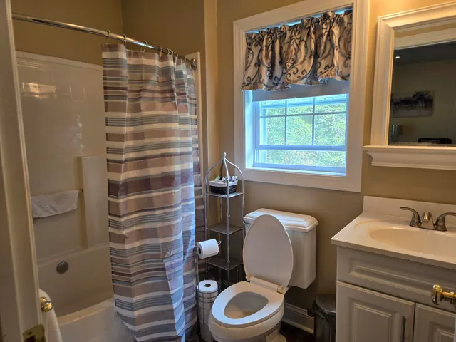 a bathroom with a toilet and a shower