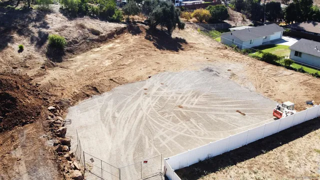 an aerial view of a house with a garden and swimming pool