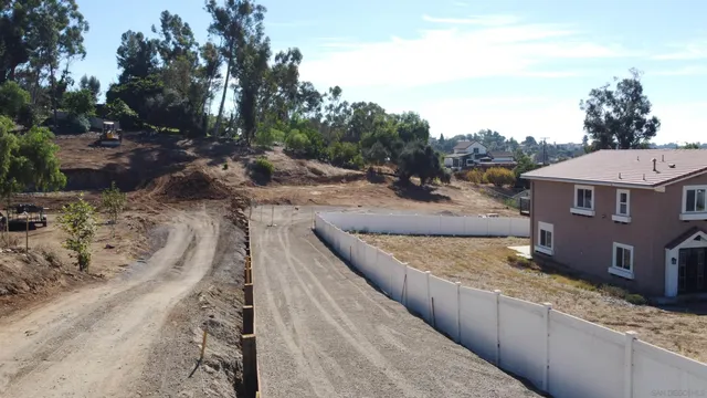 a view of a yard with plants and trees