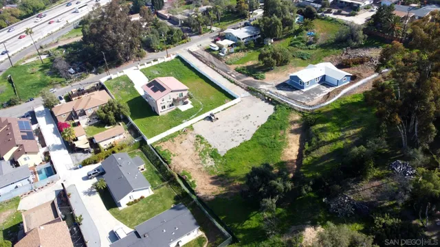 an aerial view of a house swimming pool and a yard