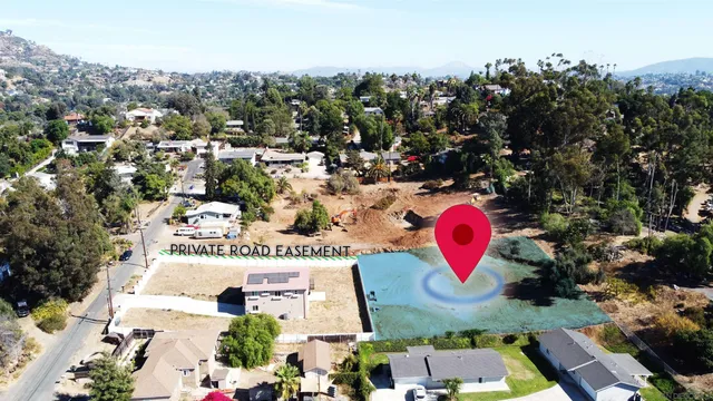 an aerial view of a house with a yard and large tree