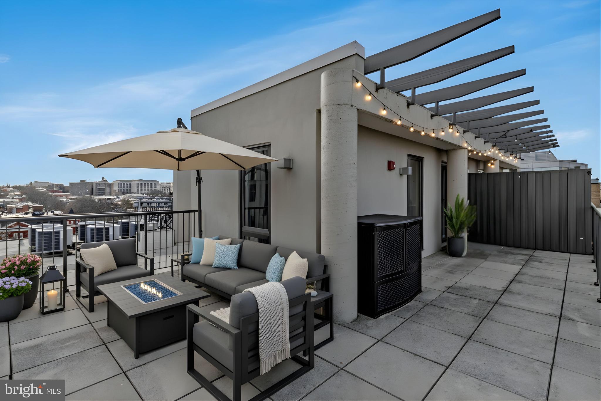 301 H Street Northeast, Unit PH602 Washington, DC 20002 - Photo 2 of 14 a patio with patio a table and chairs