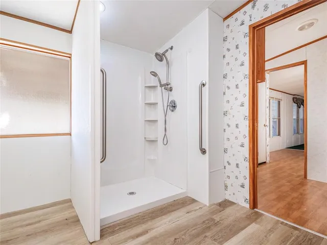 a bathroom with a glass shower door