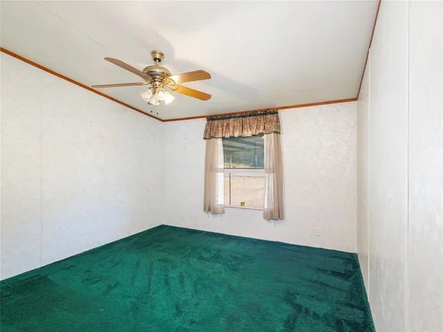 a view of room with window and ceiling fan
