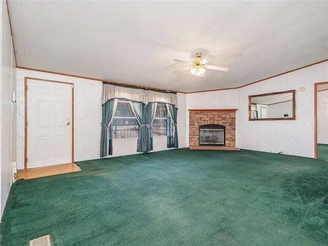 a view of livingroom with hardwood floor and a ceiling fan