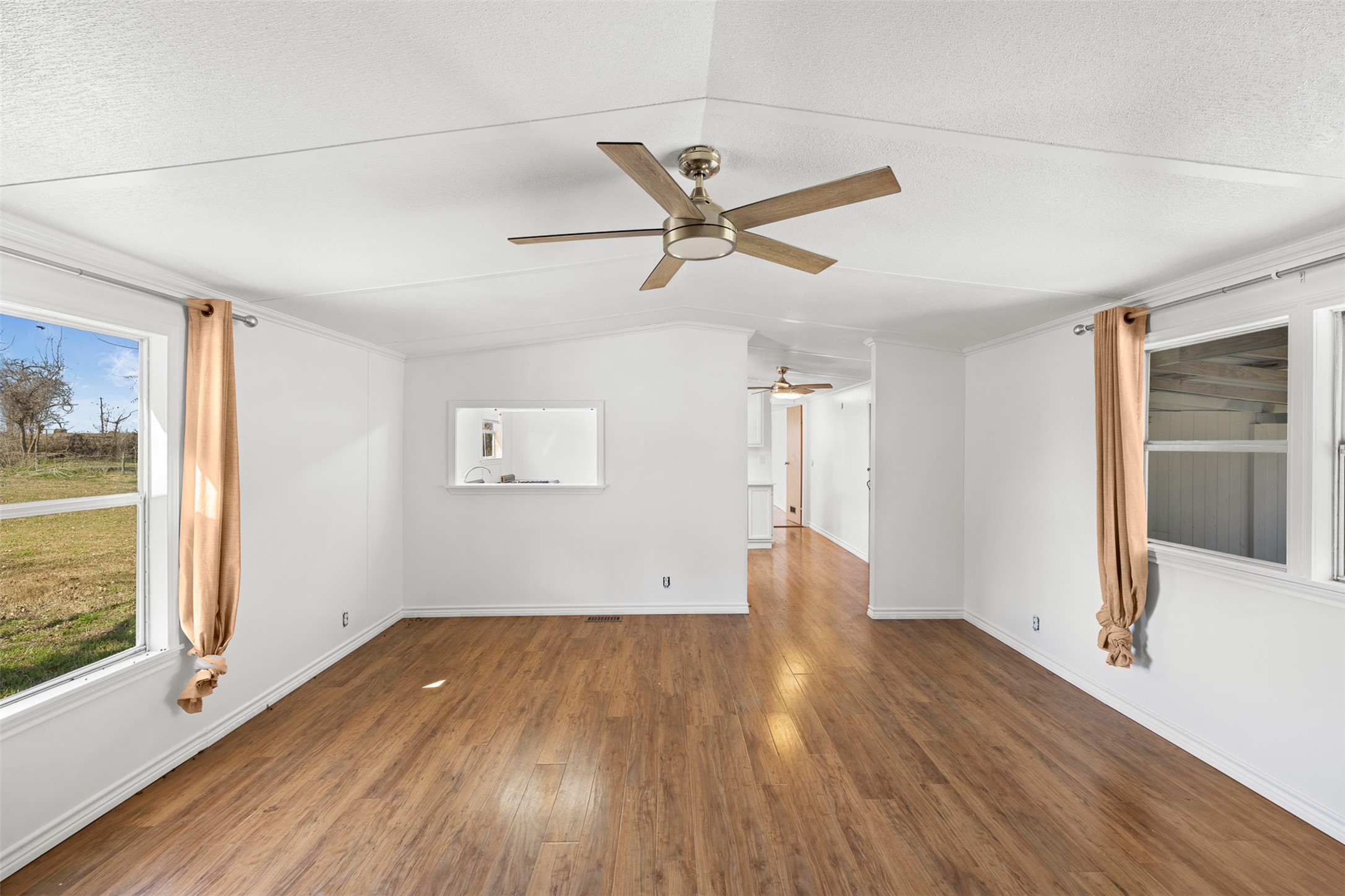 1919 County Road 344 Loop Milano, TX 76556 - Photo 5 of 21 a view of empty room with wooden floor and fan