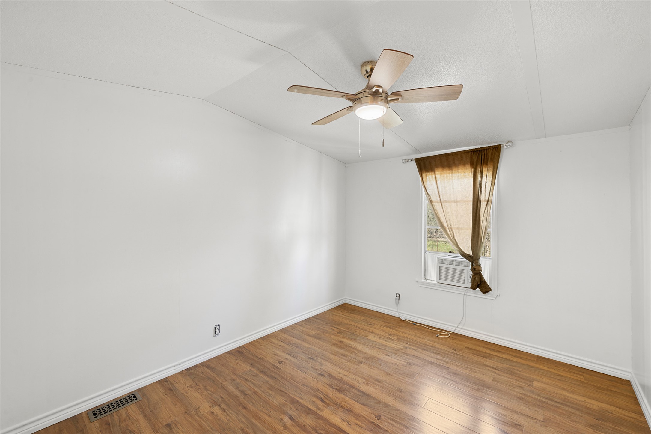 1919 County Road 344 Loop Milano, TX 76556 - Photo 9 of 21 an empty room with a window and wooden floor