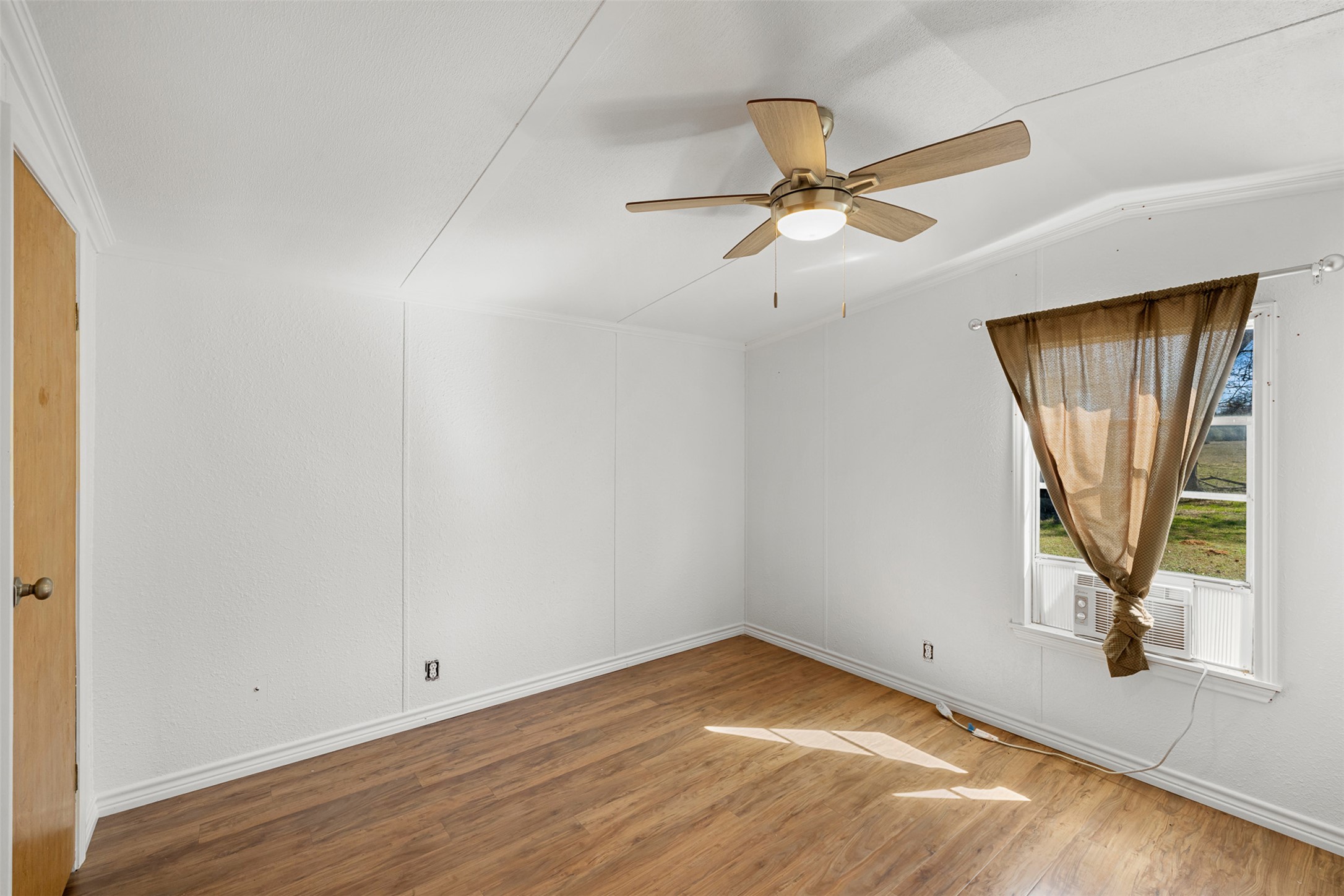 1919 County Road 344 Loop Milano, TX 76556 - Photo 10 of 21 a view of empty room with wooden floor and fan