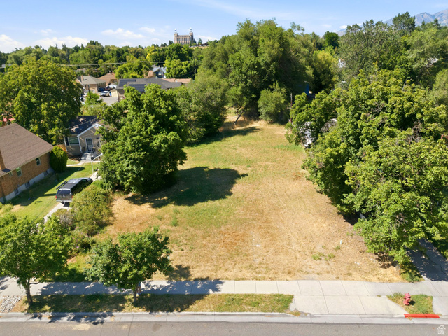 300 East S, Unit 2 Logan, UT 84321 - Photo 2 of 38 Expansive vacant lot with street frontage, mature trees, and a clear building envelope