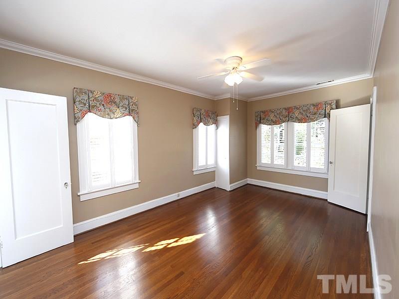 1804 St Marys Street Raleigh, NC 27608 - Photo 14 of 25 a view of an empty room with wooden floor and a window