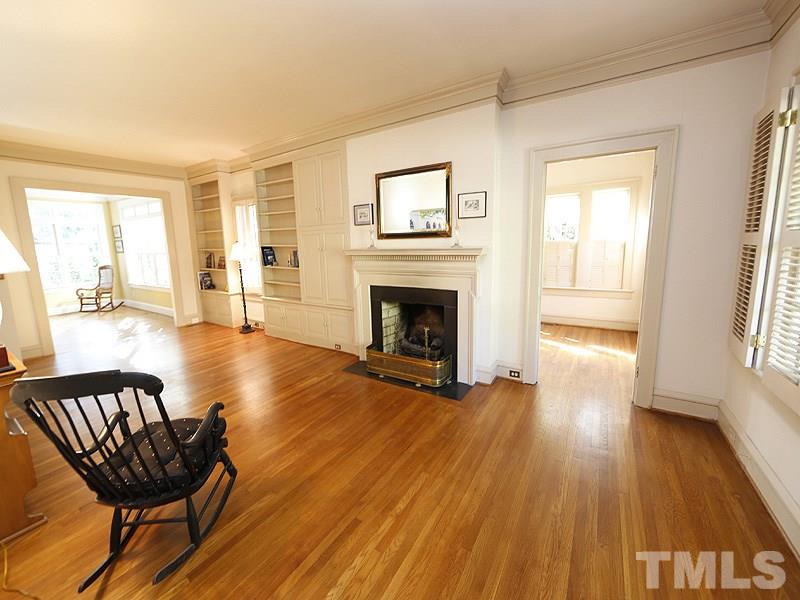 1804 St Marys Street Raleigh, NC 27608 - Photo 5 of 25 a view of a livingroom with furniture a fireplace wooden floor and windows