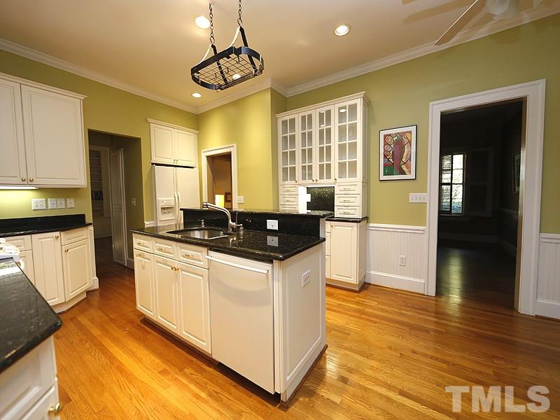 1804 St Marys Street Raleigh, NC 27608 - Photo 8 of 25 a kitchen with stainless steel appliances granite countertop a sink and a refrigerator