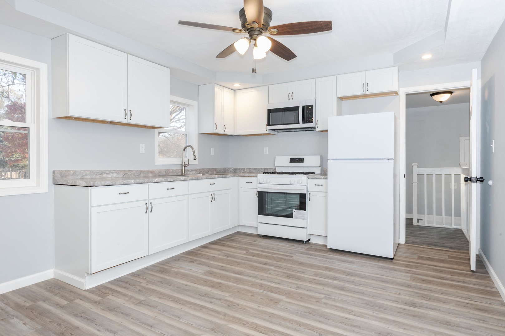 401 6th Street Cornell, IL 61319 - Photo 12 of 33 a kitchen with cabinets stainless steel appliances and wooden floor
