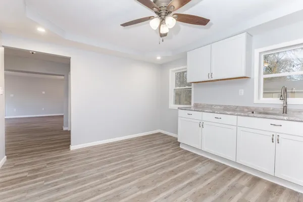 a kitchen with a sink cabinets and window