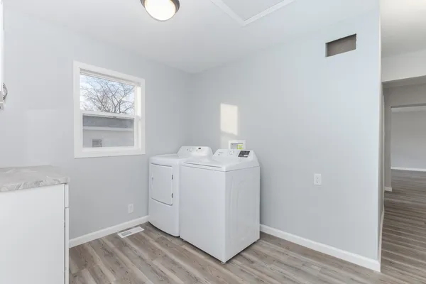 a utility room with closet dryer and washer
