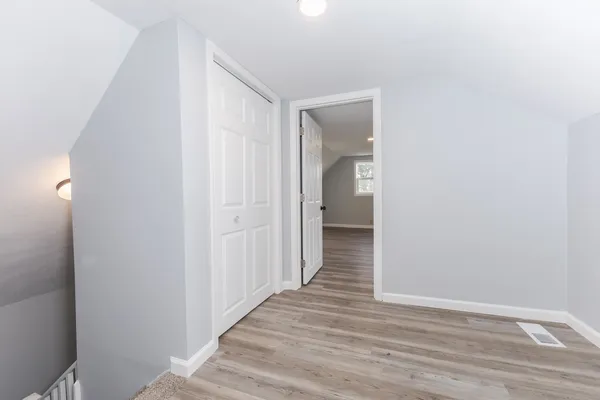 a view of a hallway with wooden floor