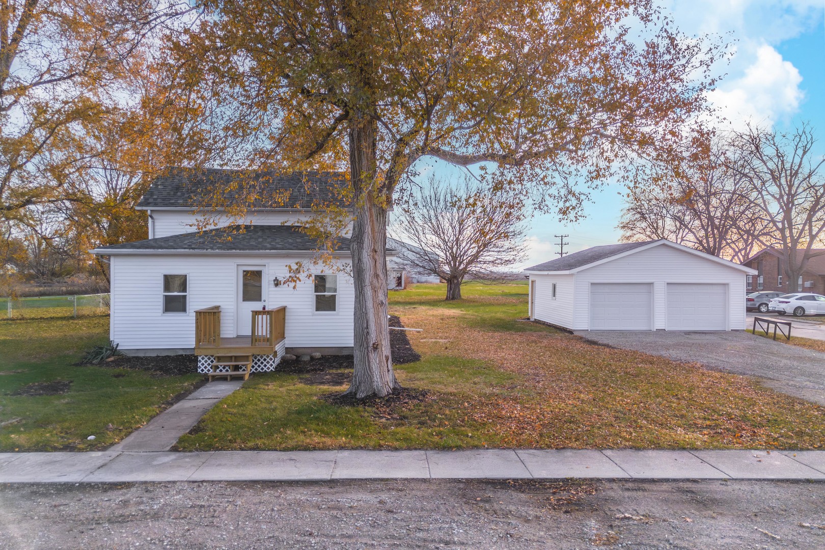 401 6th Street Cornell, IL 61319 - Photo 27 of 33 a white house that has a tree in front of it