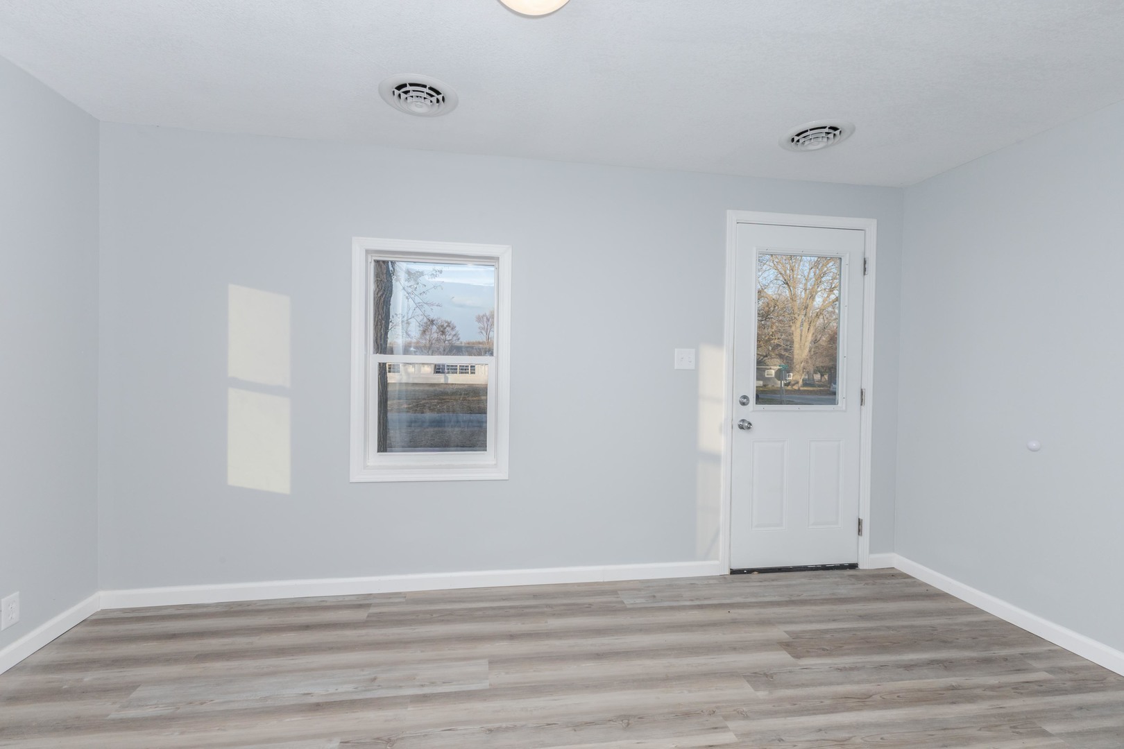 401 6th Street Cornell, IL 61319 - Photo 5 of 33 a view of an empty room with wooden floor and a window