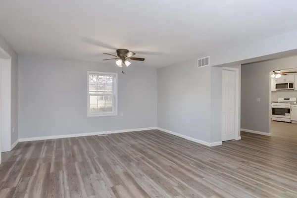 wooden floor in an empty room with a window