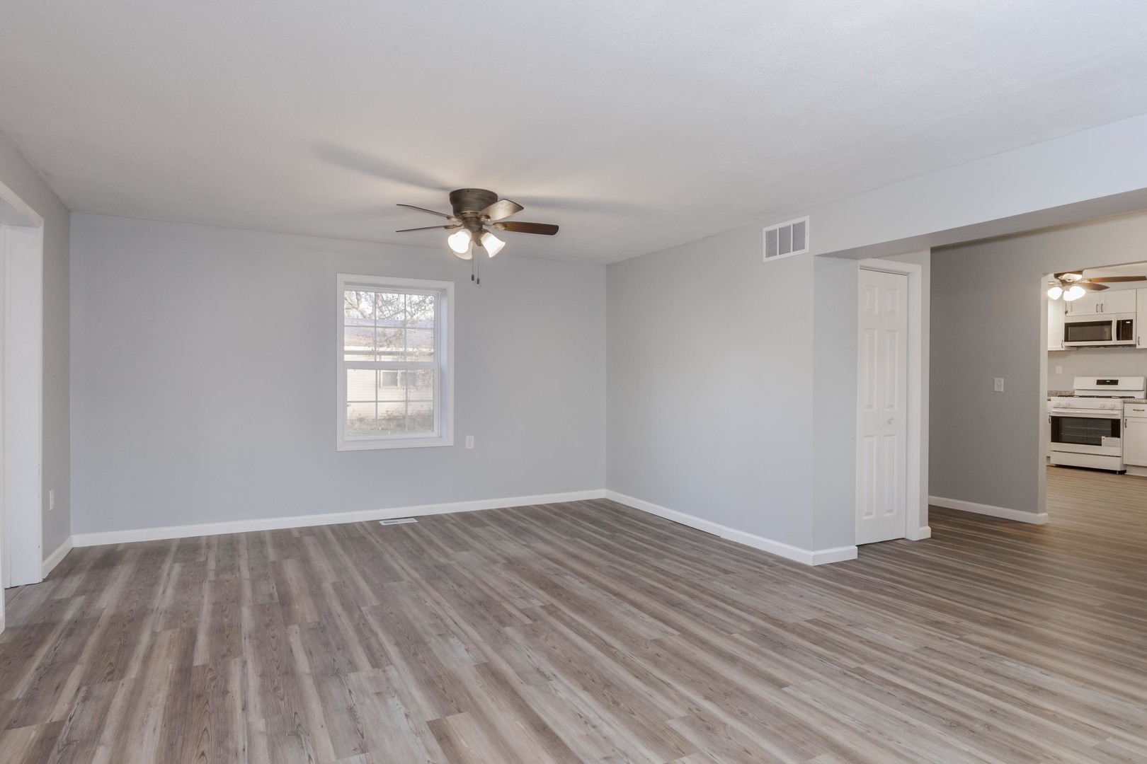 401 6th Street Cornell, IL 61319 - Photo 6 of 33 wooden floor in an empty room with a window