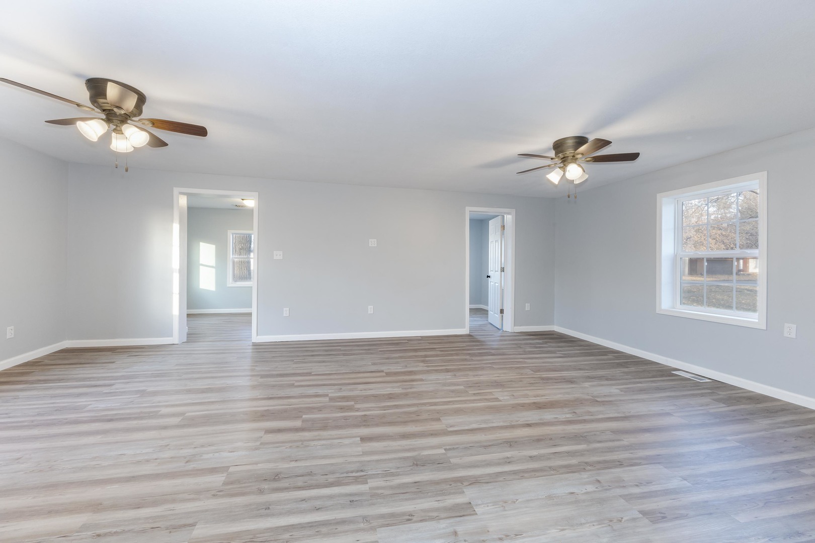 401 6th Street Cornell, IL 61319 - Photo 9 of 33 a view of an empty room with a window and wooden floor