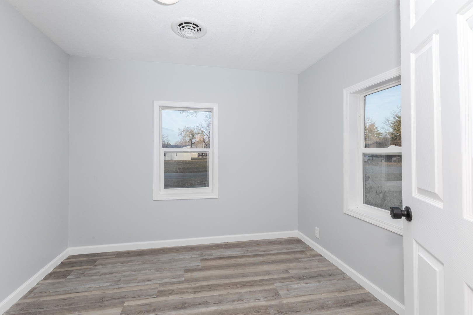 401 6th Street Cornell, IL 61319 - Photo 10 of 33 a view of an empty room with wooden floor and a window