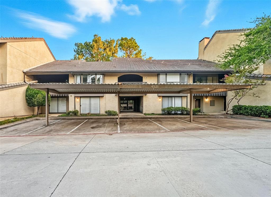4521 North O'Connor Road, Unit 2169 Irving, TX 75062 - Photo 14 of 17 a front view of a residential apartment building with a yard