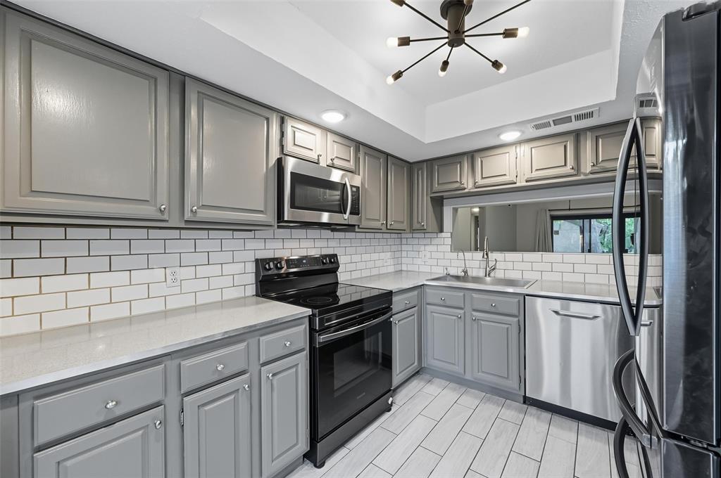 4521 North O'Connor Road, Unit 2169 Irving, TX 75062 - Photo 4 of 17 a kitchen with a sink stainless steel appliances and cabinets