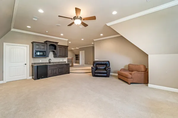 a spacious bedroom with a bed and a chandelier