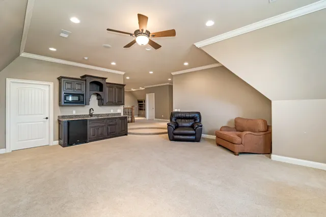 a spacious bedroom with a bed and a chandelier