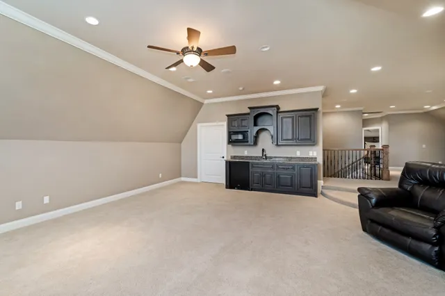 a bathroom with a granite countertop sink a mirror and shower
