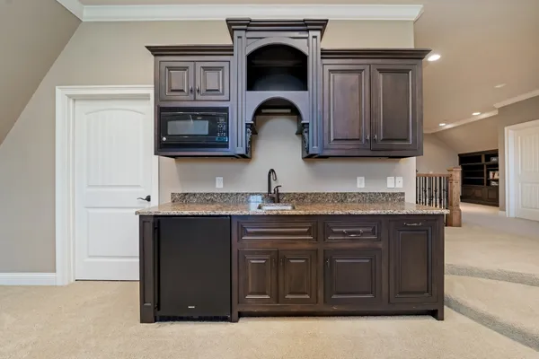 a view of a dining room with furniture and a chandelier